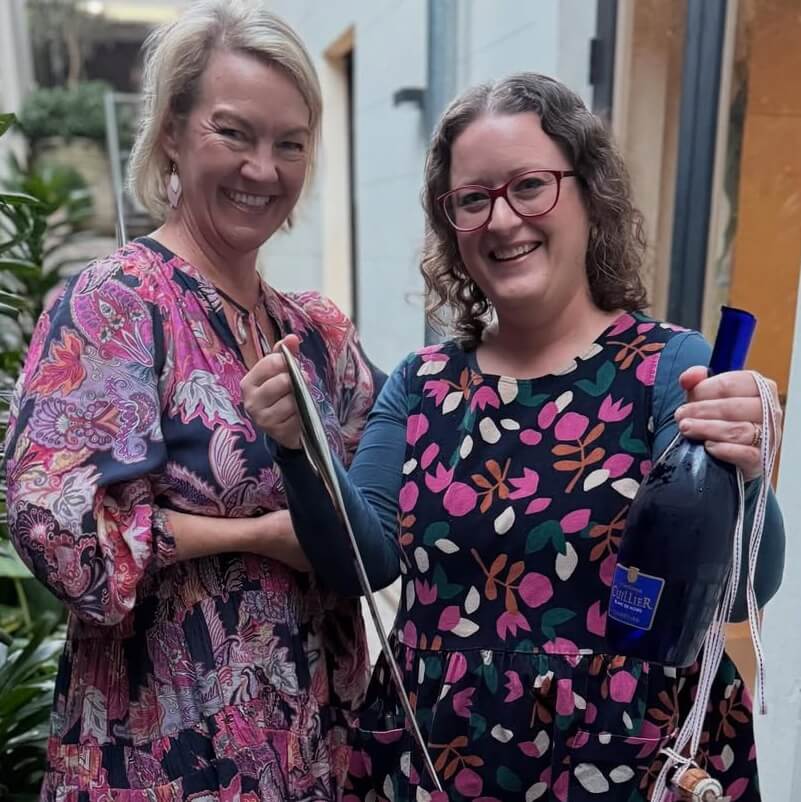 Susan Le Roux the Champagne Goddess with Tour Guest learning Sabrage on her July 2025 Sydney French Immersion Weekends